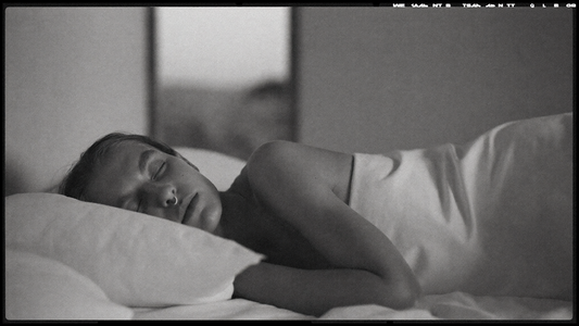 Personne allongée sur le côté, yeux fermés, respirant calmement par le nez pendant la nuit — photographie éditoriale noir et blanc OXYZÈNE